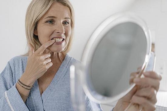 How menopause can affect oral health, including tooth decay, dry mouth, and shifting teeth